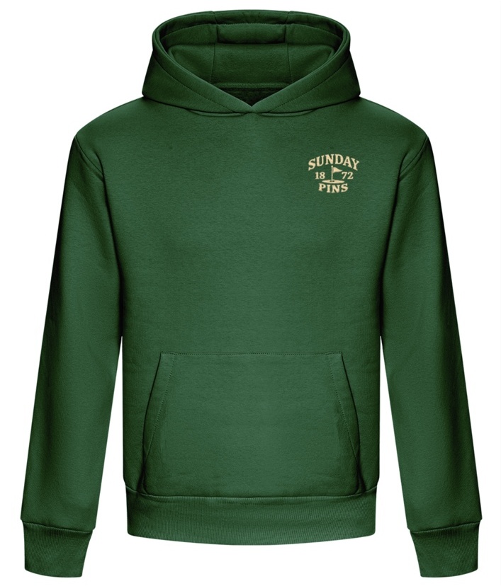 Cream embroidered chest badge on the green hoodie